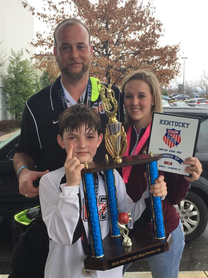 Brycen and his family pose after basketball game